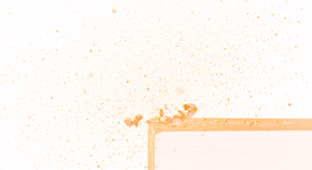 Golden Wood Shavings in Motion Against a White Background.