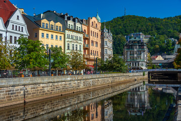 Colourful houses reflecting on Tepla river in Karlovy Vary, Czec