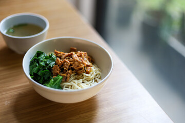 Mie ayam. Noodle with chopped chicken and boiled vegetable. served with chicken broth.