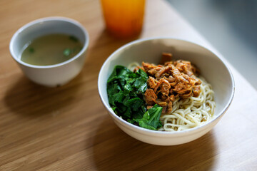 Mie ayam. Noodle with chopped chicken and boiled vegetable. served with chicken broth.