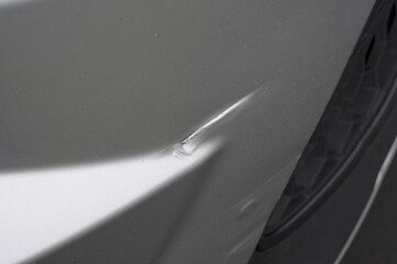 Scratch on side of car. Broken vehicle detail or close up.