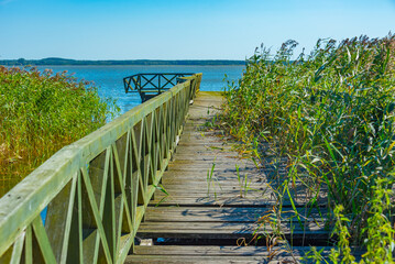 Obraz premium Broken pier at Leba lake in Slowinski national park in Poland