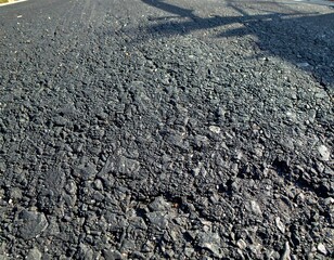Close-up of dark asphalt road surface