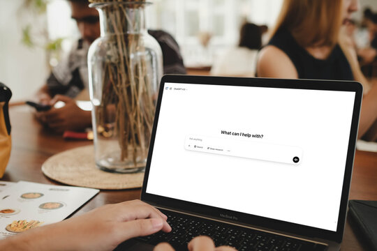 Bangkok, Thailand. SEP 2, 2025; A person using the ChatGPT 5 AI chatbot on a MacBook Pro laptop in a bustling cafe, asking the AI for assistance with a task.
