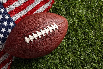 Obraz premium American Football on Grass with US Flag Pattern for Sports Event Background, Patriotic Theme, and Game Day Promotion.