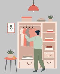 A person selects clothing from a tidy, well-organized closet, illustrating daily routine, choice, and a minimalist lifestyle in a cozy home interior