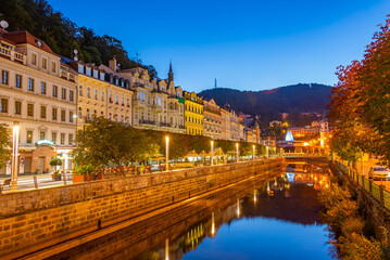 Fototapeta premium Night view of colourful houses reflecting on Tepla river in Karl