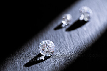 Closeup of sparkling diamonds with shadows on dark background, symbol of luxury, jewelry, wealth,...