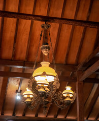 Vintage Chandelier in the traditional javanese houses Hanging from Wooden Ceiling