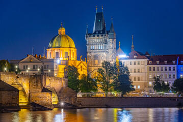 Fototapeta premium Sunset view of Charles bridge and Saint Salvator church in Pragu