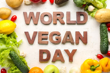Text WORLD VEGAN DAY with different fresh vegetables and fruits on white background