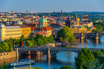 Obraz premium Sunset view of Charles bridge and Saint Salvator church in Pragu
