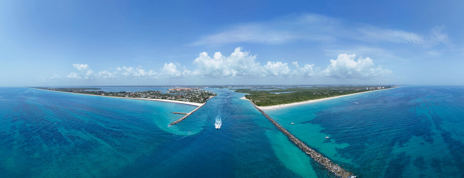 Aerial panorama view of boat heading to sea in Fort Pierce Inlet on the Treasure Coast of Florida in St. Lucie County