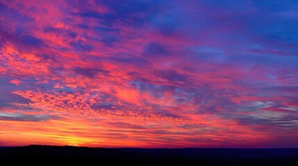 Fototapeta premium Breathtaking sunset sky with vibrant hues of pink, orange, and purple, painting clouds in an ethereal display that highlights nature's beauty and captures the serene magic of dusk.