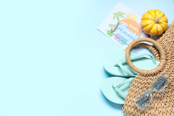 Card for Thanksgiving Day with beach accessories and pumpkin on blue background