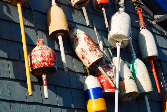 Colorful lobster buoys hang on a wall of a seafood restaurant in New England