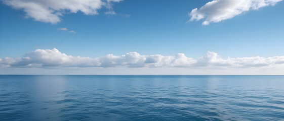 Obraz premium Peaceful coastal horizon with calm blue sea and soft sky clouds, tranquil scenic view.