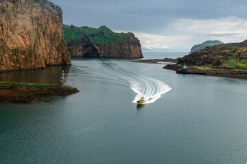 Tour boat cruising toward the port of Heimaey a town of 4,000 residents.
