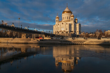 View of the Cathedral of Christ the Savior and the Patriarchal Bridge from the Beresnevskaya embankment of the Moskva River on a sunny winter day, Moscow, Russia
