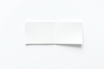 Fototapeta premium A single torn piece of white paper with a shadow on a white background