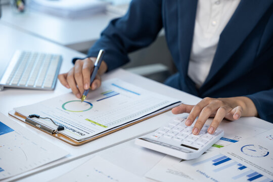 Analyzing financial reports office workspace business document professional environment close-up view data insights for women in business