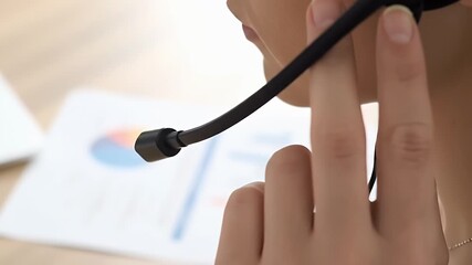 Close Up Of A Woman Wearing Headset At Desk Reviewing Documents - Powered by Adobe