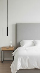 Minimalist bedroom with white bedding grey headboard and wooden nightstand with pendant light interior