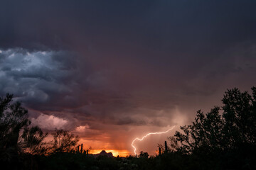 Lightning at sunset in the sonoran desert with colorful clouds