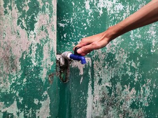 The right hand turns off the water tap