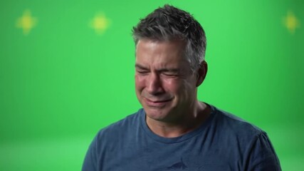 Man with tears in his eyes, expressing sadness and emotional distress.