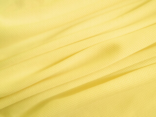 Yellow fabric background. Wavy cloth texture