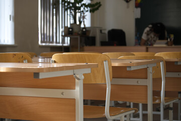 Empty classroom with desks and chairs awaiting students and their lessons.