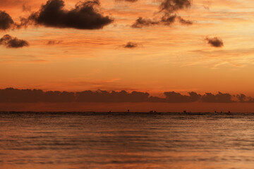 Sunset over the ocean with jukung boats on the horizon, Bali