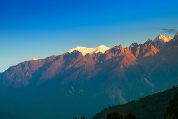 Beautiful first light from sunrise on Mount Kabru, part of ridge that extends south from third...
