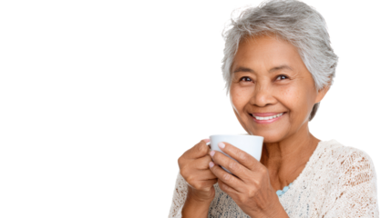 Smiling elderly woman holding a white cup, exuding warmth and joy.