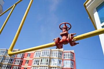A gas pipe on the background of multi-storey residential buildings, on the outskirts of the city.