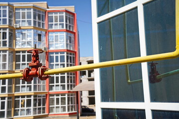 Almaty, Kazakhstan - 08.29.2025 : A gas pipe on the background of multi-storey residential...