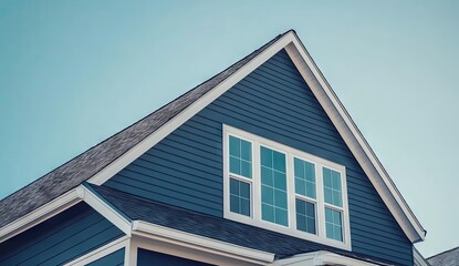 A house with a dark blue siding and white trim.