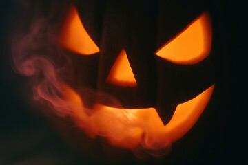 Fototapeta premium A glowing jack-o'-lantern with smoky accents captures the essence of Halloween, perfect for festive decorations, events, and seasonal promotions.