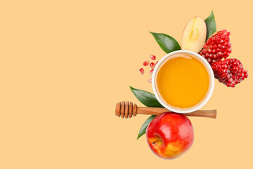 Arrangement of honey bowl with apples and pomegranates nearby