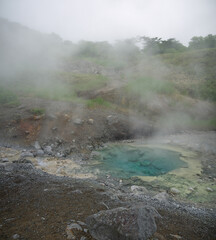 Emerald Eye hot Thermal pool with rising steam on Iturup, Kuril islands
