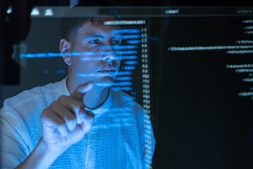Professional IT Technical Support Specialist or Software Developer pointing and analyzing code in control room of computers.