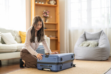 Portrait of backpacker beauty asian traveler woman packing prepare stuff and outfit clothes in...