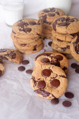 freshly baked homemade chocolate chip cookies on baking paper background