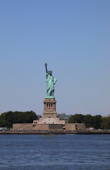 Fototapeta premium famous statue of liberty one of new yorks most iconic symbols seen from a boat