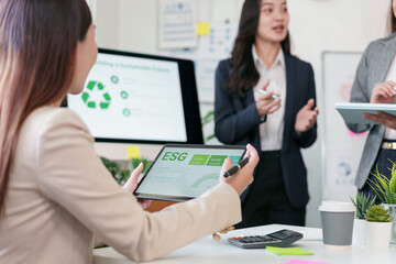 ESG report tablet business meeting sustainability presentation corporate discussion office teamwork female professional tablet computer digital display presentation screen eco graphic