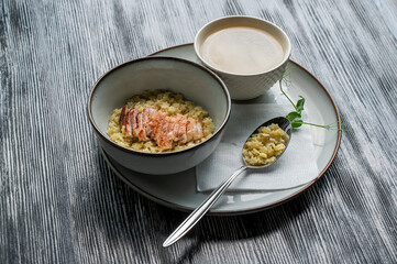 Chicken broth with noodles on a wooden table. 