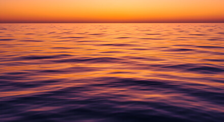 Vibrant Orange and Purple Sunset over Calm Ocean Waves with Horizon