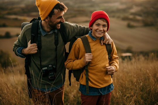 Father and son hiking together in scenic landscape