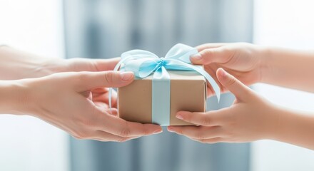 A childs hands receive a gift from an adults hands, symbolizing giving and receiving with joy and care